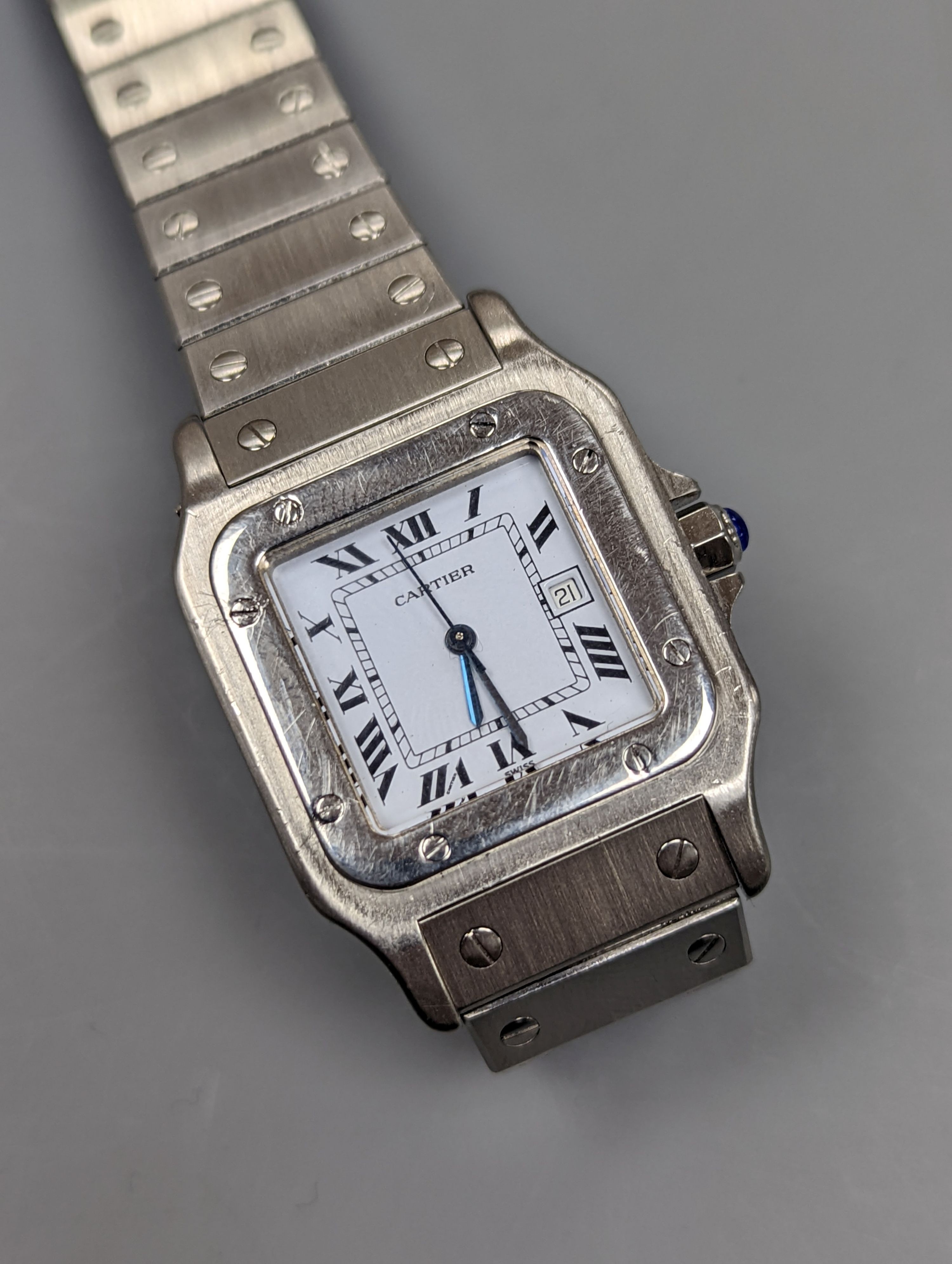 A gentleman's stainless steel Cartier Santos automatic wristwatch, on a stainless steel Cartier bracelet, no box or papers, cased diameter 30mm.